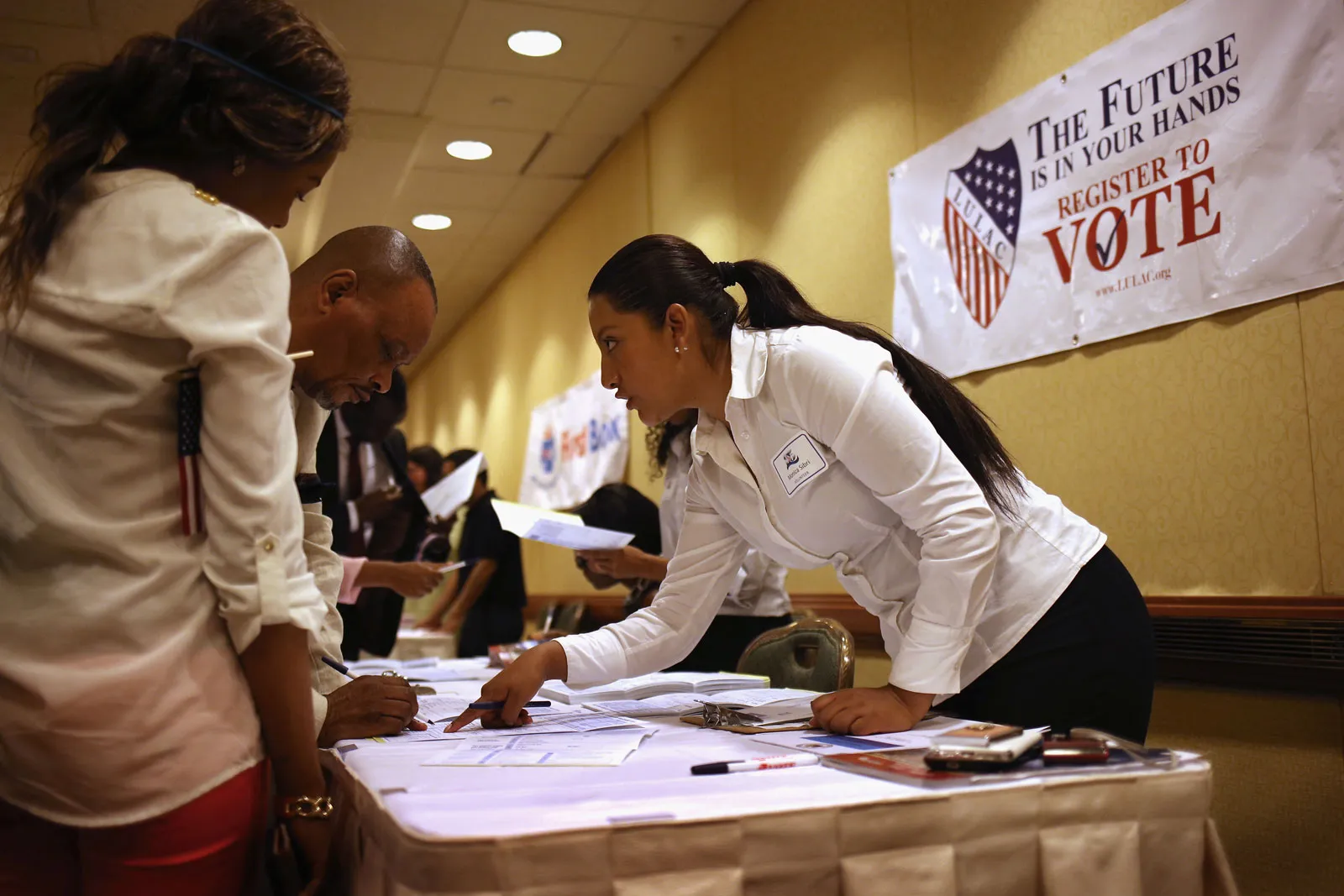 LULAC volunteer helping voters register
