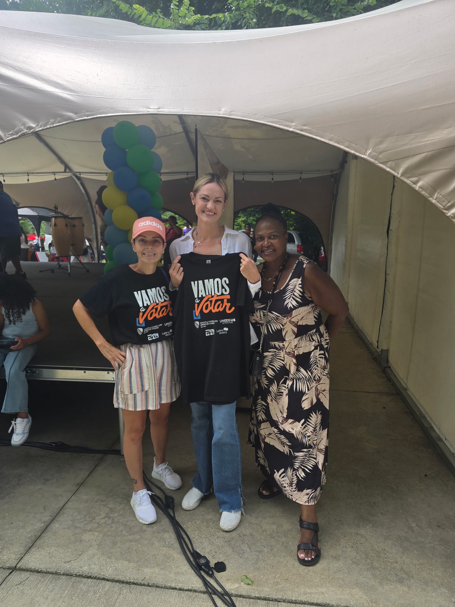 Volunteers with Vamos a Votar shirts at a community festival